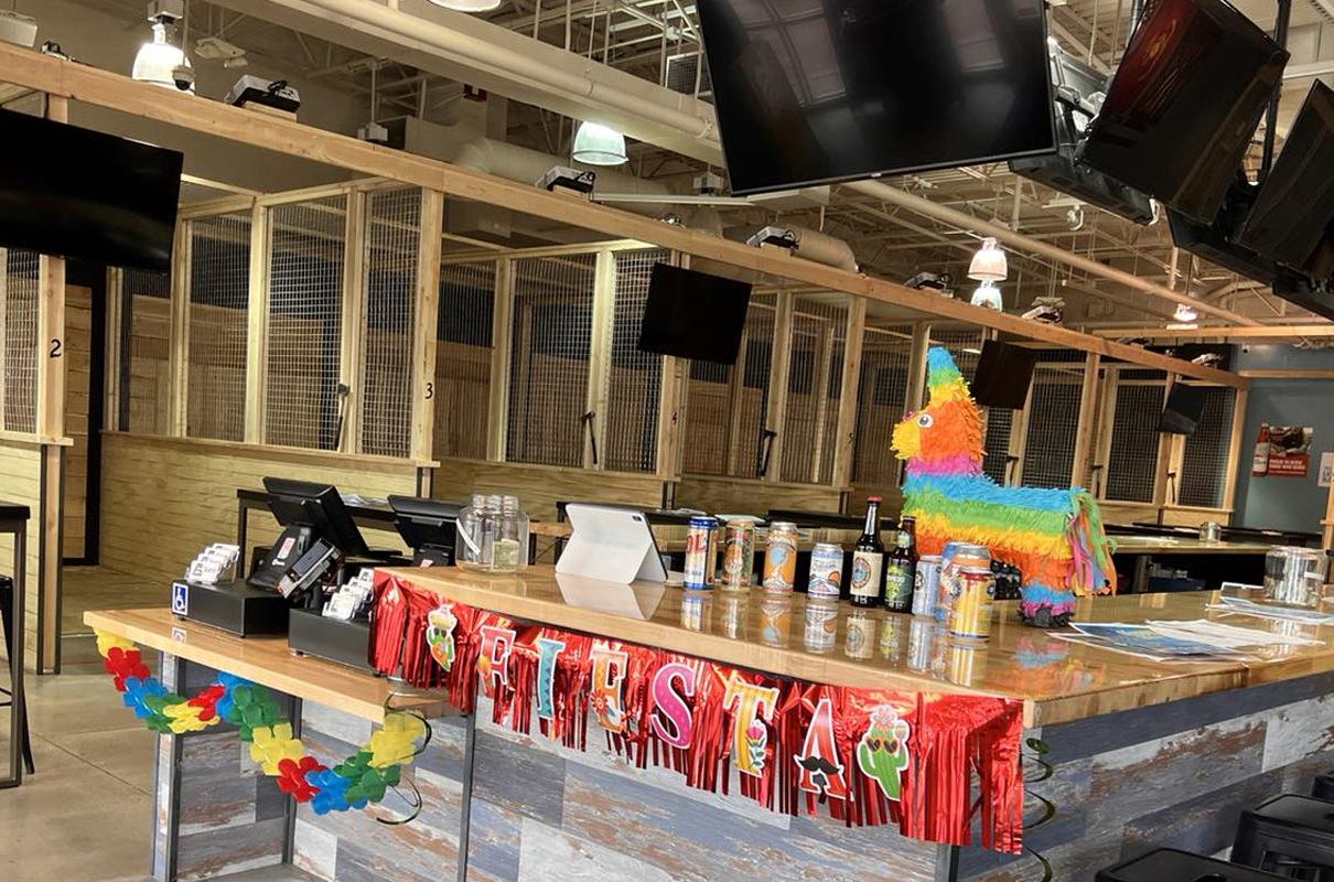 special fiesta event in an axe throwing bar during the day with a pinata on the bar table
