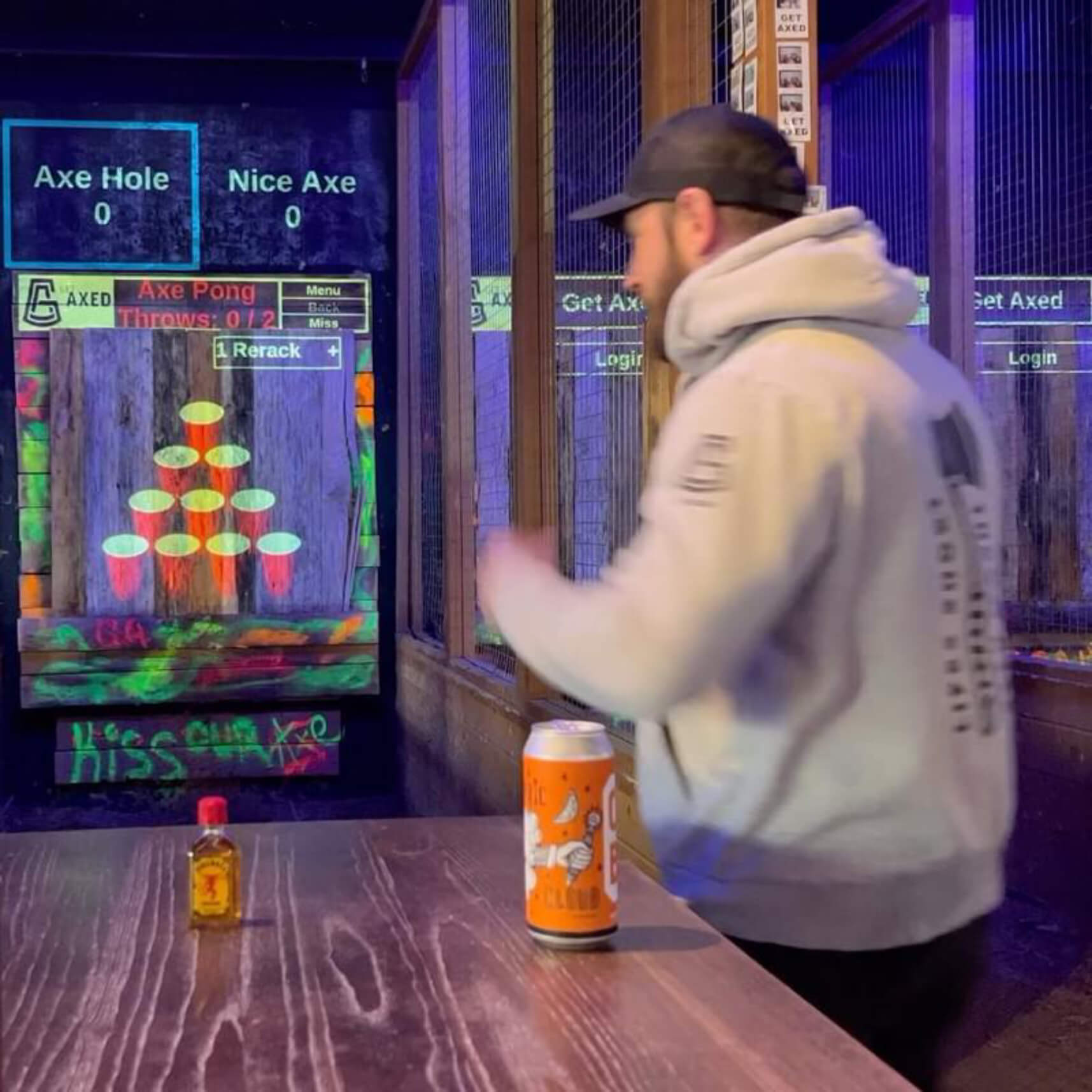 man playing axe pong at an axe throwing bar 1